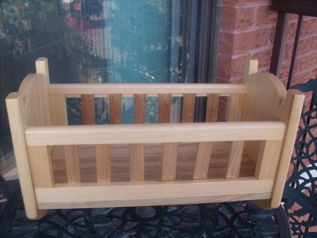 photo of a doll cradle / seat.